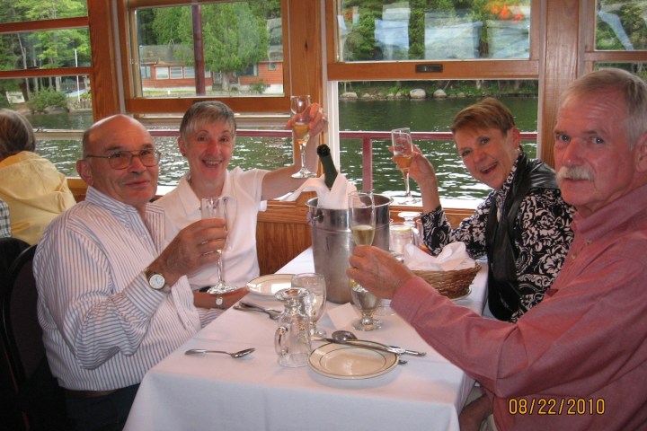 a group of people sitting at a table with wine glasses