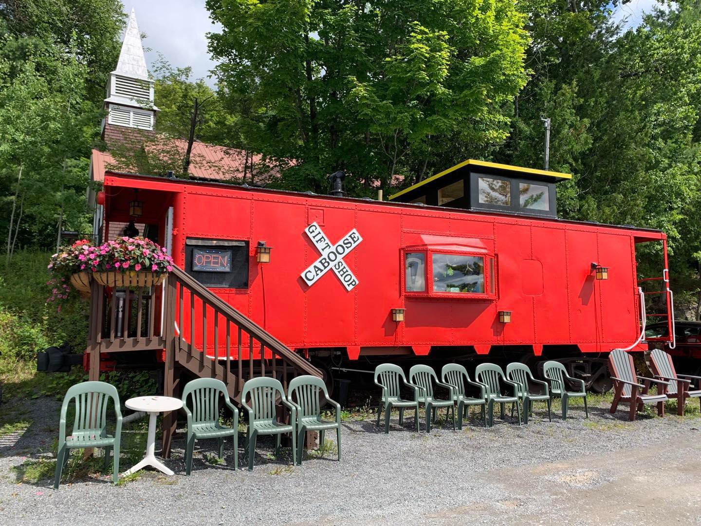 caboose a train is parked on the side of a fence